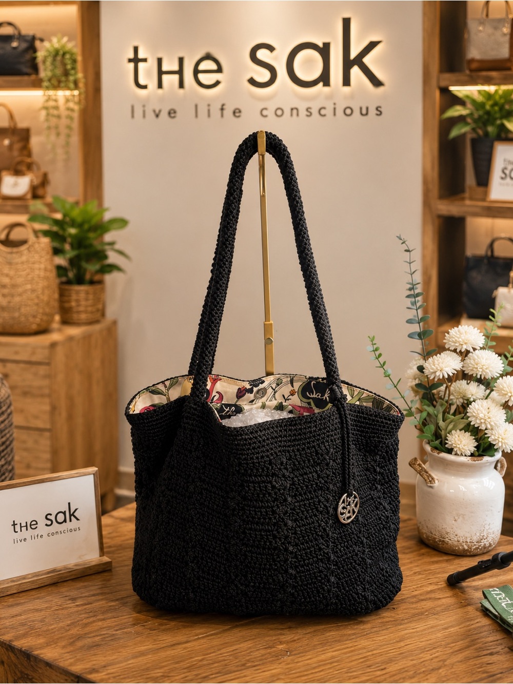 The Sak Black Woven Shoulder Bag with Floral Lined Interior